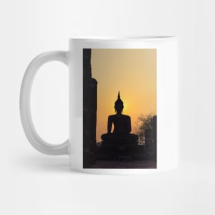 Buddha statue against sunset silhouette Mug